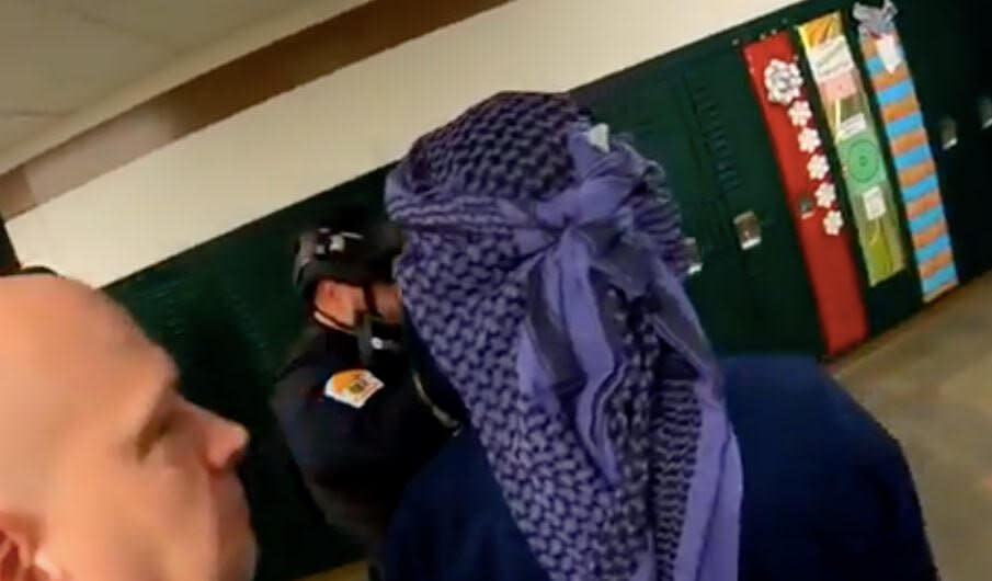 A Penn-Trafford School District teacher is seen wearing a checkered purple and black scarf around his head in a video of an active shooter training drill. (Photo: Penn-Trafford School District )