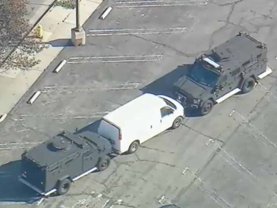 Two SWAT vehicles are seen confronting a white van potentially linked to the Monterey Park shooting (ABC7)