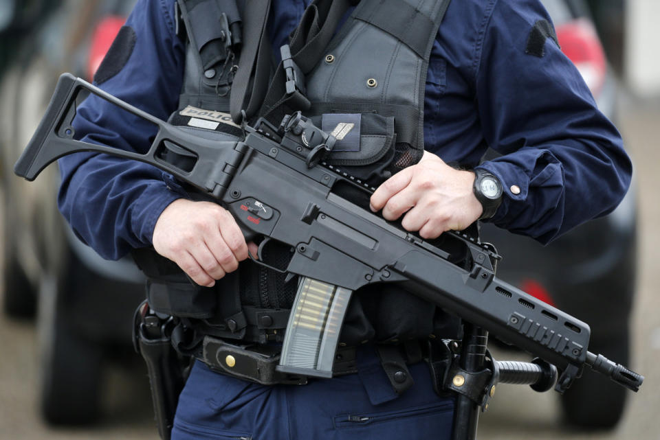 <p>A policeman holds a HKG36 assault rifle as he secures the position in front of the city hall after two assailants had taken five people hostage in the church at Saint-Etienne-du-Rouvray near Rouen in Normandy, France, July 26, 2016. (REUTERS/Pascal Rossignol)</p>