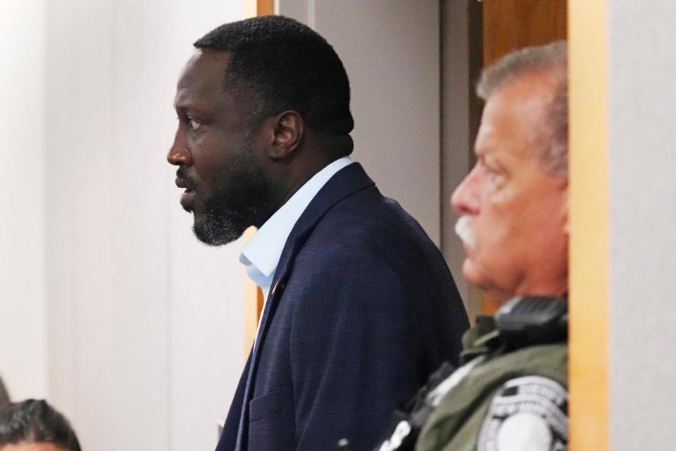 Strafford County Sheriff Mark Brave walks past a law enforcement officer while arriving in court, Thursday, Sept. 28, 2023, in Brentwood, N.H. Brave, who pleaded not guilty, is accused of using his county credit card to pay for travel to fictitious business meetings with multiple paramours and then lying about it to a grand jury