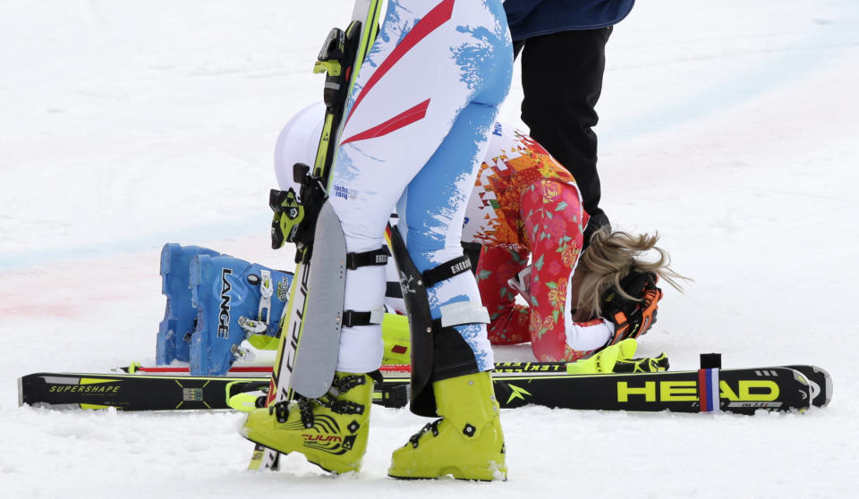 Germany's Maria Hoefl-Riesch drops to her knees the moment she realizes she has won the gold medal in the women's supercombined at the Sochi 2014 Winter Olympics, Monday, Feb. 10, 2014, in Krasnaya Polyana, Russia. (AP Photo/Gero Breloer)