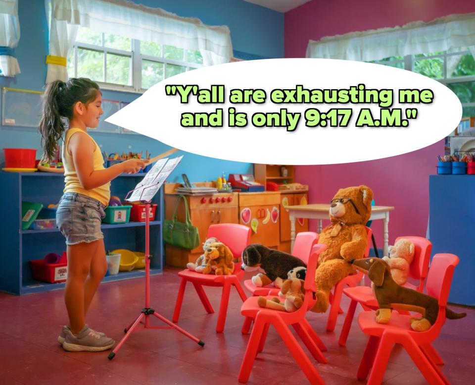 A little girl teaching her stuffed animals