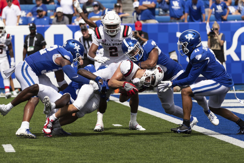 Kentucky defenders tackle Ball State tight end Tanner Koziol (88) during the second half of an NCAA college football game in Lexington, Ky., Saturday, Sept. 2, 2023. Kentucky defenders from left are linebacker Trevin Wallace (32), defensive back Alex Afari Jr. (3), linebacker Keaten Wade (20) and defensive back Zion Childress (11). (AP Photo/Michelle Haas Hutchins)