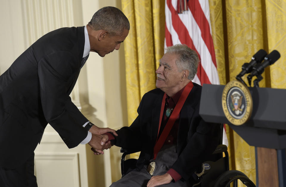 FILE - In this Sept. 22, 2016, file photo, President Barack Obama shakes hands with author, Rudolfo Anaya, after presenting him with the 2015 National Humanities Medal during a ceremony in the East Room of the White House in Washington. Anaya, 82, who helped launch the 1970s Chicano Literature Movement with his novel "Bless Me, Ultima," died Sunday, June 28, 2020. (AP Photo/Susan Walsh, File)