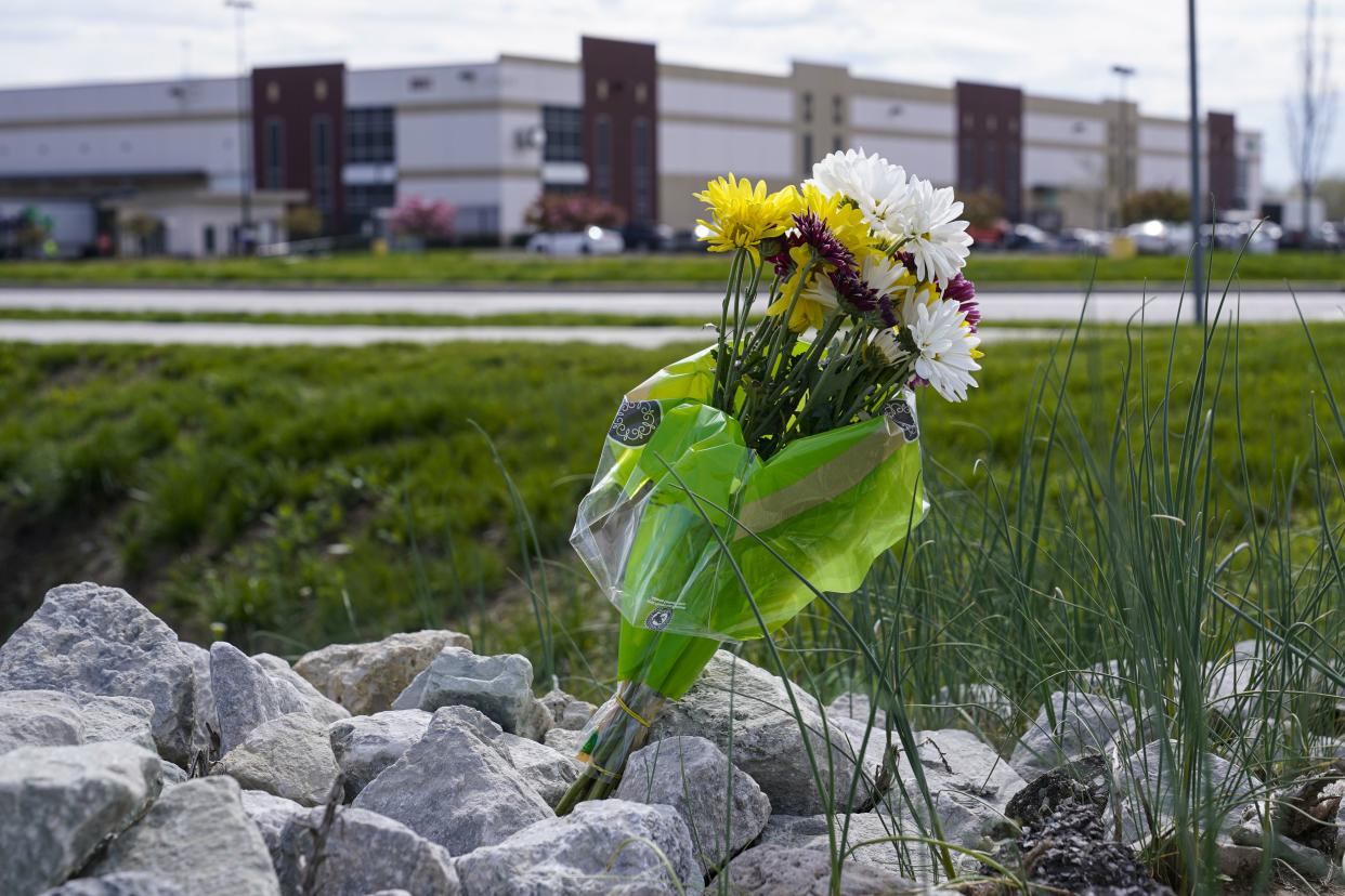 A single bouquet of flower sits in the rocks across the street from the FedEx facility in Indianapolis, Saturday, April 17, where eight people were shot and killed. 
