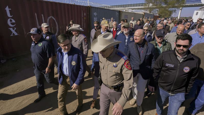 U.S. House Speaker Mike Johnson, center left, and Texas Department of Public Safety chief Steve McCraw, center right, lead a group of Republican members of Congress during a tour of the Texas-Mexico border on Jan. 3, 2024, in Eagle Pass, Texas. About 60 fellow Republicans in Congress visited the Mexican border. They are demanding hard-line immigration policies in exchange for backing President Joe Biden’s emergency wartime funding request for Ukraine.