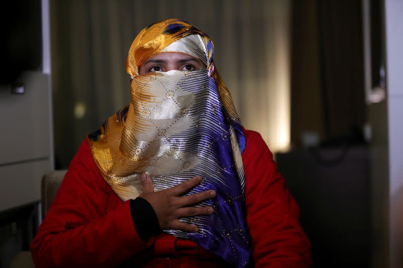 Hasina Begum, a survivor of ethnic-based violence against the Rohingya minority in Myanmar, gestures as she speaks during an interview at the Crowne Plaza Hotel in The Hague