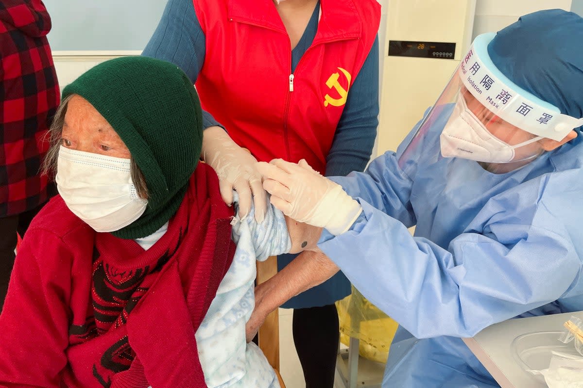An elderly resident is vaccinated against Covid in Zhongmin village near Shanghai on Wednesday (REUTERS)