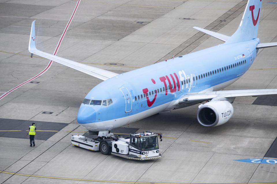 A Tui aircraft is pushed out of its parking position on the apron of Duesseldorf Airport for Flight X3 2312 to Mallorca, Duesseldorf, Germany, Monday, June 15, 2020. After the travel warning for 27 European countries was lifted in the night to Monday this morning for the first time a plane with holidaymakers took off after a weeks-long corona break. (Marcel Kusch/dpa via AP)