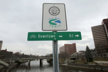 A Flint River sign is seen along the Flint river in Flint, Michigan in this December 16, 2015 file photo. REUTERS/Rebecca Cook/Files