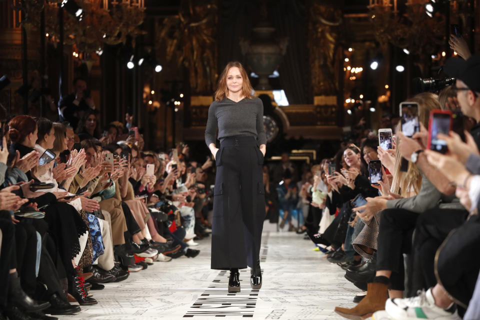 FILE - Designer Stella McCartney accepts applause at the conclusion of her ready to wear Fall-Winter 2019-2020 collection, that was presented in Paris, March 4, 2019. McCartney among hundreds of Britons honored by Queen Elizabeth II on Wednesday as she celebrates 70 years on the throne. (AP Photo/Thibault Camus, File)