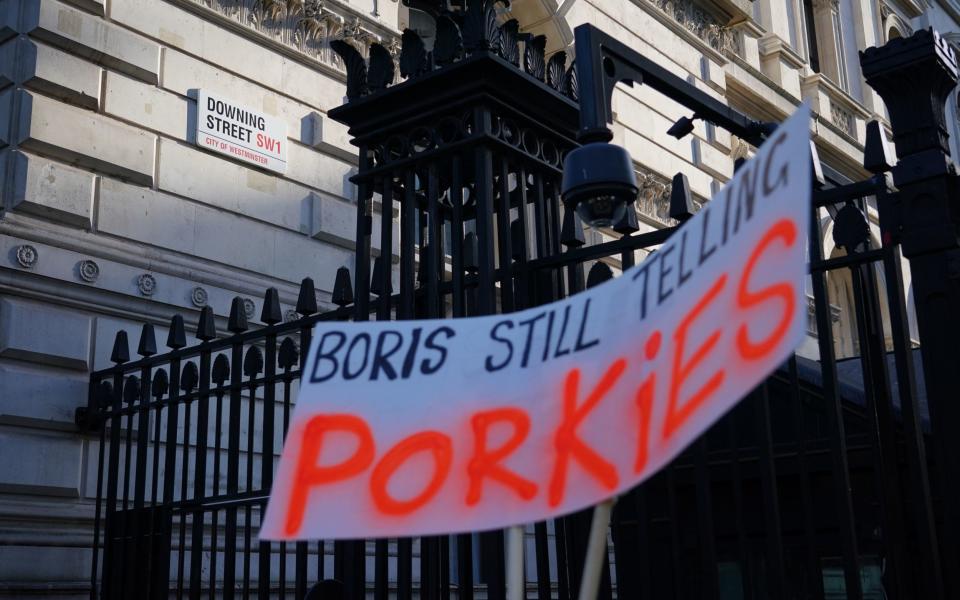 A banner outside Downing Street on Tuesday night, reading: "Boris still telling porkies" - Dominic Lipinski/PA