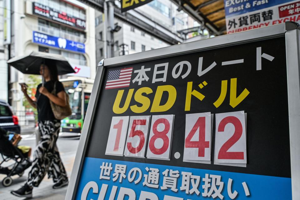 A woman walks past a currency exchange shop in central Tokyo on June 30, 2024, after the yen slid late the week before to its weakest value against the US dollar since 1986.
