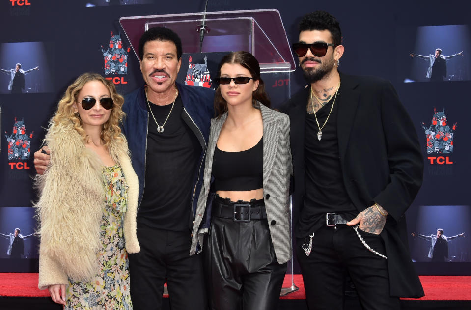 Lionel Ritchie with his children Nicole (L), Sofia and Miles (R) pose at his Hand and Footprints ceremony at the TCL Theater on March 7,2018 in Hollywood, California. / AFP PHOTO / FREDERIC J. BROWN        (Photo credit should read FREDERIC J. BROWN/AFP via Getty Images)