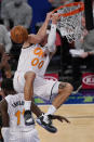 Orlando Magic forward Aaron Gordon (00) hangs on the rim after an unsuccessful dunk during the third quarter of an NBA basketball game, Monday, Jan. 18, 2021, in New York. (AP Photo/Kathy Willens, Pool)