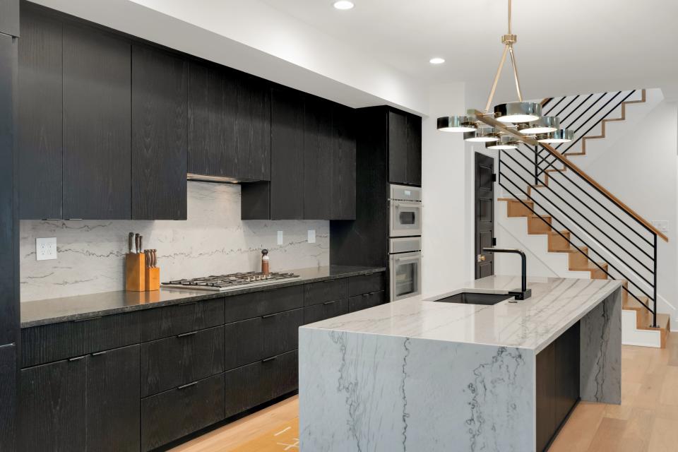 The kitchen at this home in Louisville’s Rivers Edge subdivision boasts stained ebony cabinetry.