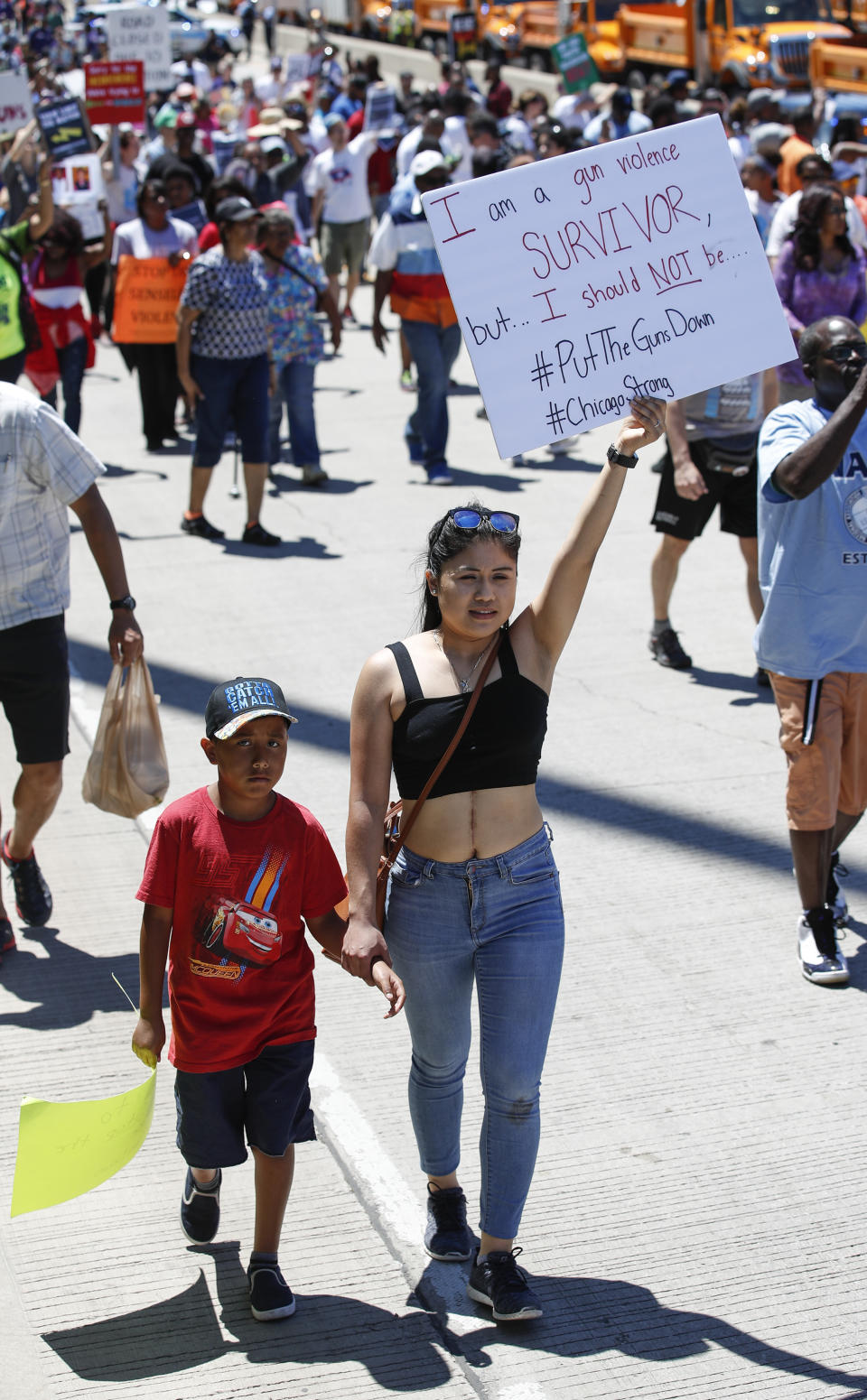 <p>An activists holds a sign as she march onto Chicago Dan Ryan Expressway to protest violence in the city on July 7, 2018 in Chicago, Ill. (Photo: Kamil Krzaczynski/Getty Images) </p>