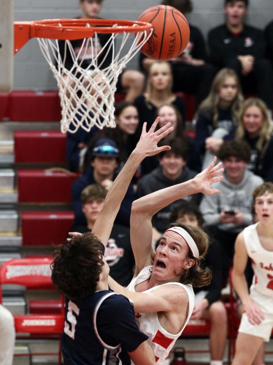 Granville junior Alex Engle puts pressure on Johnstown senior Cody Siegfried under the basket Wednesday night during the host Johnnies' 49-31 victory.