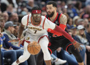 Denver Nuggets guard Reggie Jackson, front, pursues a loose ball with Toronto Raptors guard Fred VanVleet in the first half of an NBA basketball game,Monday, March 6, 2023, in Denver. (AP Photo/David Zalubowski)