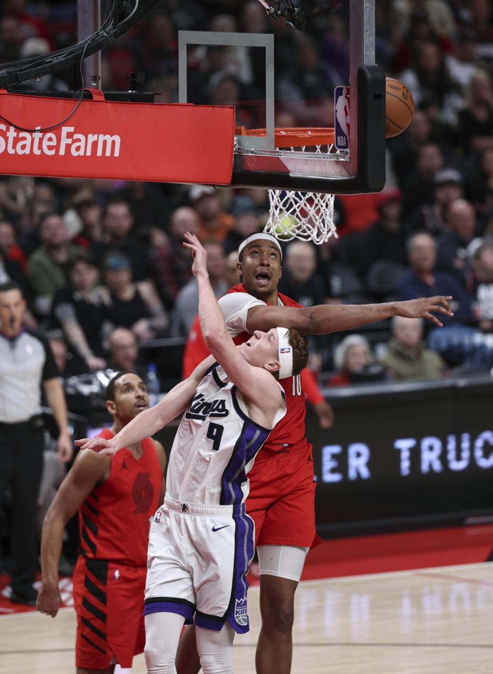 Portland Trail Blazers center Moses Brown blocks a shot by Sacramento Kings guard Kevin Huerter during the second half of an NBA basketball game Tuesday, Dec. 26, 2023, in Portland, Ore. (AP Photo/Howard Lao)