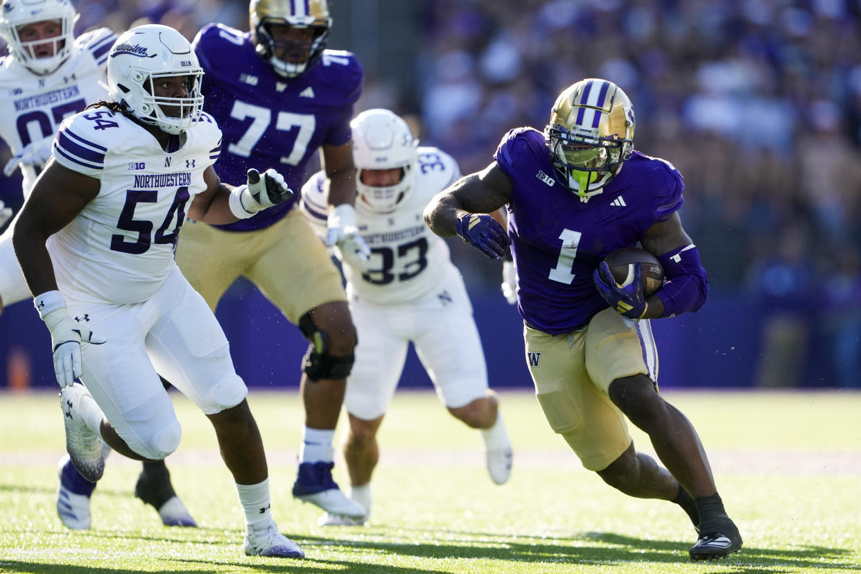 Washington running back Jonah Coleman (1) runs the football against Northwestern defensive lineman Tyler Gant (54) during the first half of an NCAA college football game Saturday, Sept. 21, 2024, in Seattle. (AP Photo/Lindsey Wasson)