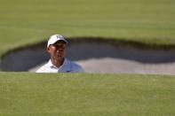 Feb 16, 2018; Pacific Palisades, CA, USA; Tiger Woods looks at his shot from a bunker on the first hole during the second round of the Genesis Open golf tournament at Riviera Country Club. Mandatory Credit: Orlando Ramirez-USA TODAY Sports