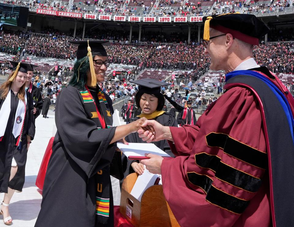 Nikia Gales shakes hands with David A. Jenkins, PhD, LCSW, the dean of Ohio State University's College of Social Work during spring commencement on May 7.