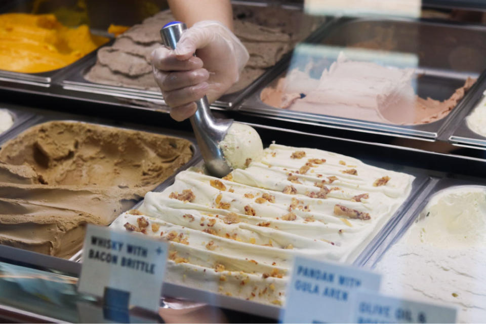 a hand scooping gelato 