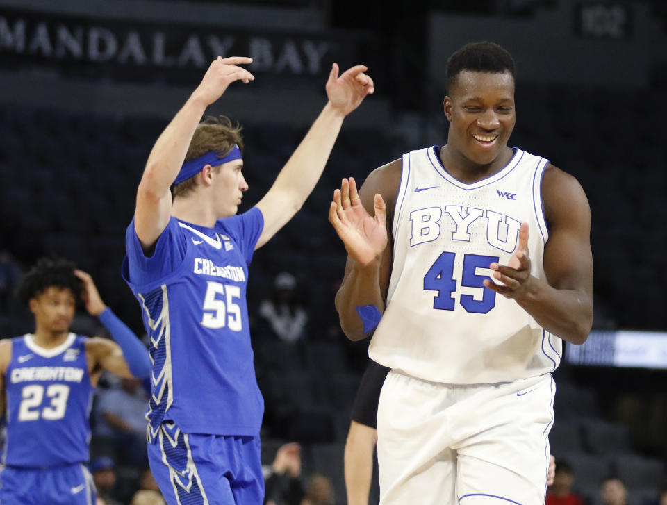 BYU forward Fousseyni Traore (45) reacts to a play, near Creighton's Baylor Scheierman (55) and Trey Alexander (23) during the second half of an NCAA college basketball game Saturday, Dec. 10, 2022, in Las Vegas. BYU won 83-80. (AP Photo/Ronda Churchill)