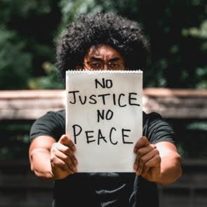 Man holds up protest sign