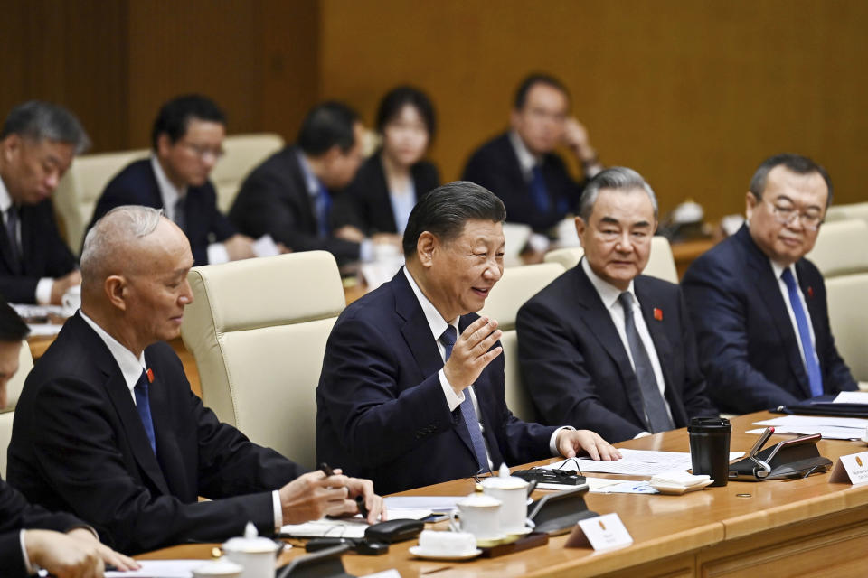 China's President Xi Jinping, second left, and Foreign Minister Wang Yi, second right, attend a meeting with Vietnam's Prime Minister Pham Minh Chinh at the government office in Hanoi, Vietnam, Wednesday, Dec. 13, 2023. (Nhac Nguyen/Pool Photo via AP)