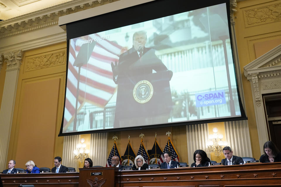 A video of Donald Trump speaking is displayed above the members of the committee. 