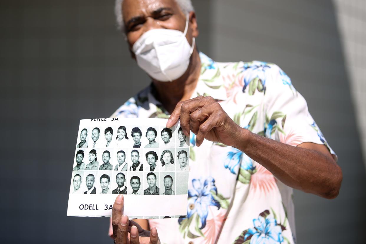 Palm Springs resident Lamar Hoke Jr. holds a photo of himself (fourth from the bottom left) and his classmates from high school on Thursday, August 6, 2020, in Palm Springs, Calif. Hoke, now 78,  was in high school when he heard from his sister, Connie Stanley, after being separated from her following their mother's passing.  Then came decades of searching.