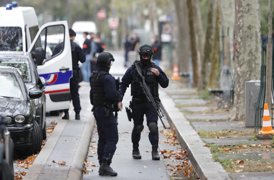 Riot police officers arrive after four people have been wounded in a knife attack near the former offices of satirical newspaper Charlie Hebdo, Friday Sept. 25, 2020 in Paris. A police official said officers are "actively hunting" for the perpetrators and have cordoned off the area including the former Charlie Hebdo offices after a suspect package was noticed nearby. Islamic extremists attacked the offices in 2015, killing 12 people. (AP Photo/Thibault Camus)
