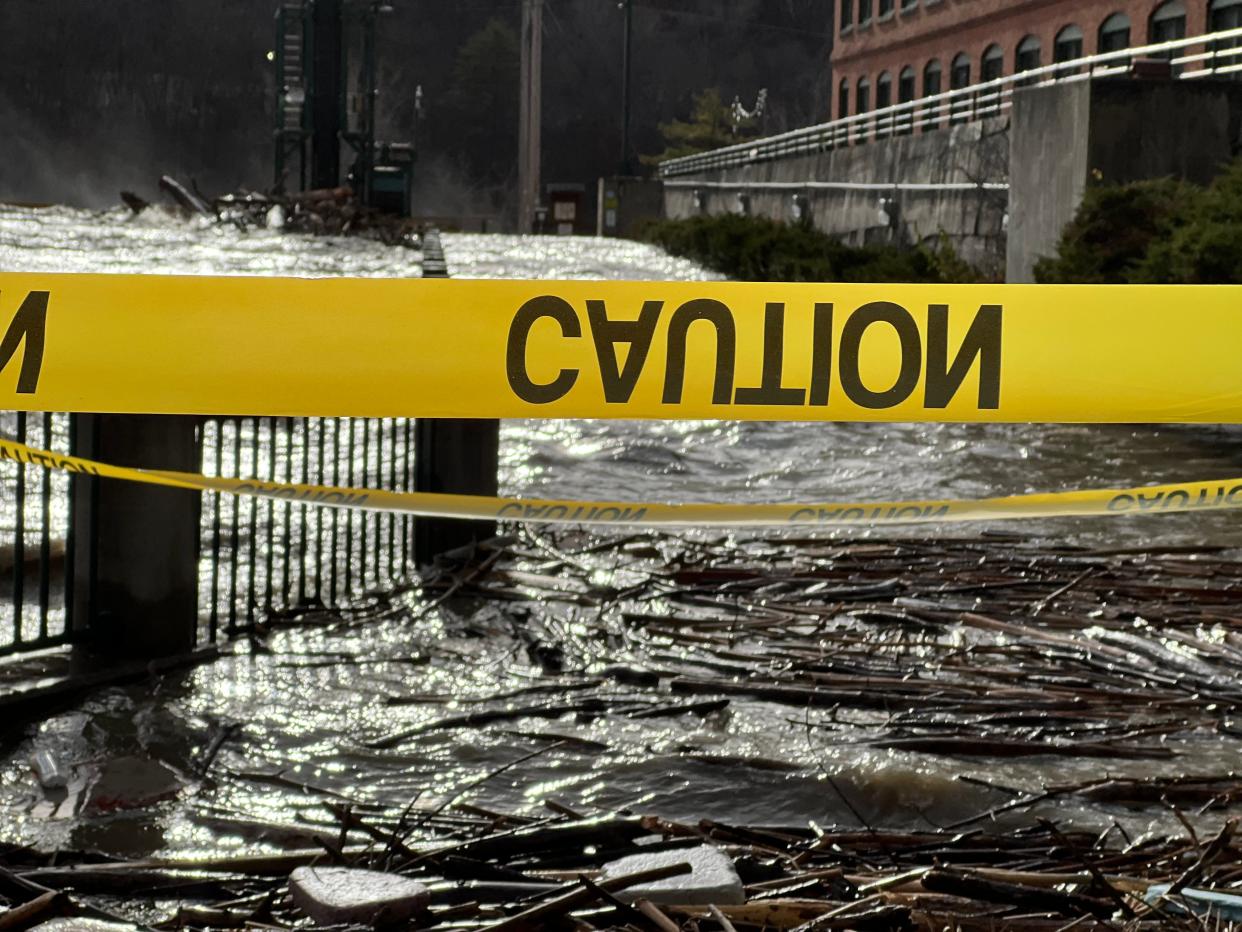 The Winooski River roiled between Winooski and Burlington, overflowing its banks past Winooski Falls Park and spilling over the Hydro One plant and dam on Dec.19, 2023 following a major rain and snowmelt event.