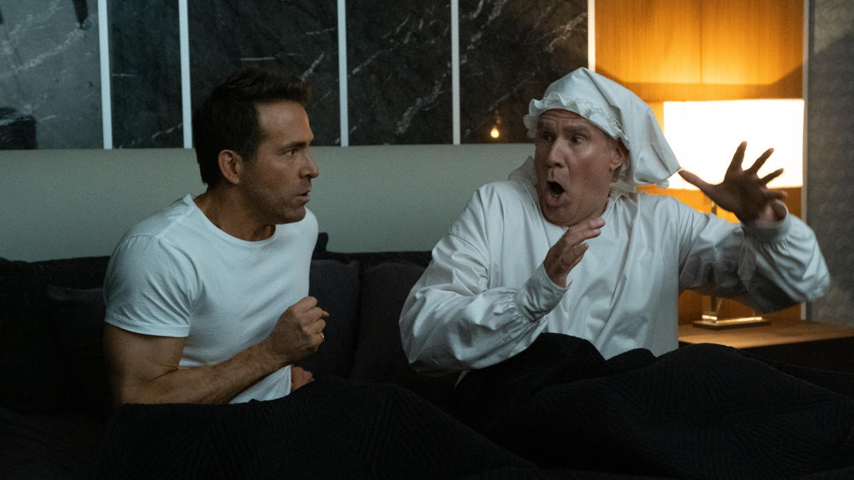 Clint Briggs (Ryan Reynolds) proves to be a match for the Ghost of Christmas Present (Will Ferrell) in Spirited. (Apple TV+)