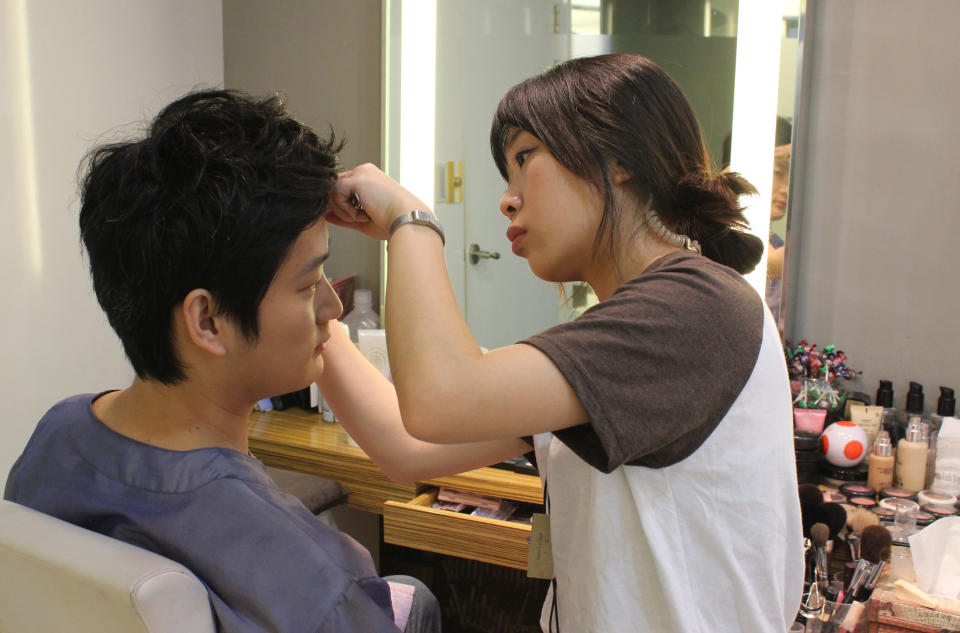 In this July 30, 2013 photo, Chen Jingjing of Beijing, China, tilts his head as a South Korean stylist fills in Chen’s eyebrows with a pencil in southern Seoul, South Korea. China is the source of one quarter of all tourists to South Korea, and a handful of companies in South Korea’s $15 billion wedding industry are wooing an image-conscious slice of the Chinese jet set happy to drop several thousand dollars on a wedding album with a South Korean touch. (AP Photo/Elizabeth Shim)