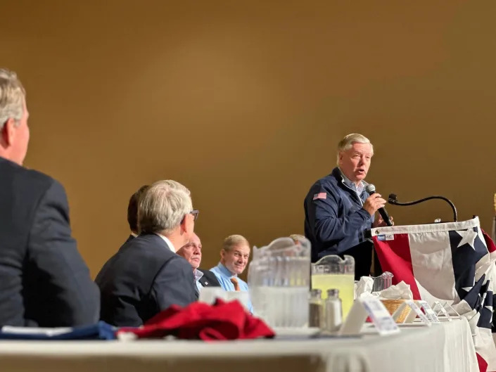 Graham speaks at a Republican dinner in Lima, Ohio as Jordan looks on.