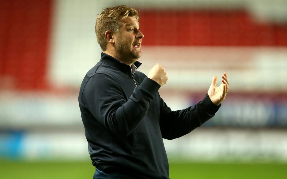 Oxford United's Karl Robinson inspects the pitch before the Sky Bet League One match at The Valley, London. - PA