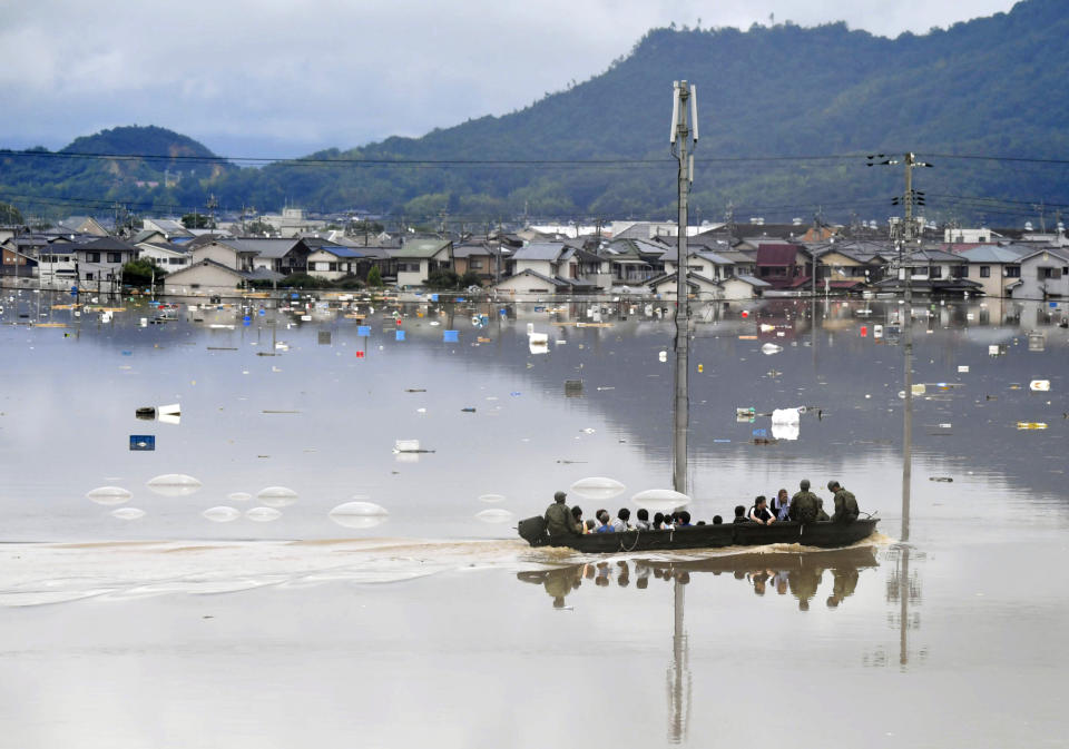 <p>Residents are rescued from a flooded area by Japan Self-Defense Force soldiers in Kurashiki, southern Japan, in this photo taken by Kyodo July 7, 2018. (Photo: Kyodo via Reuters) </p>