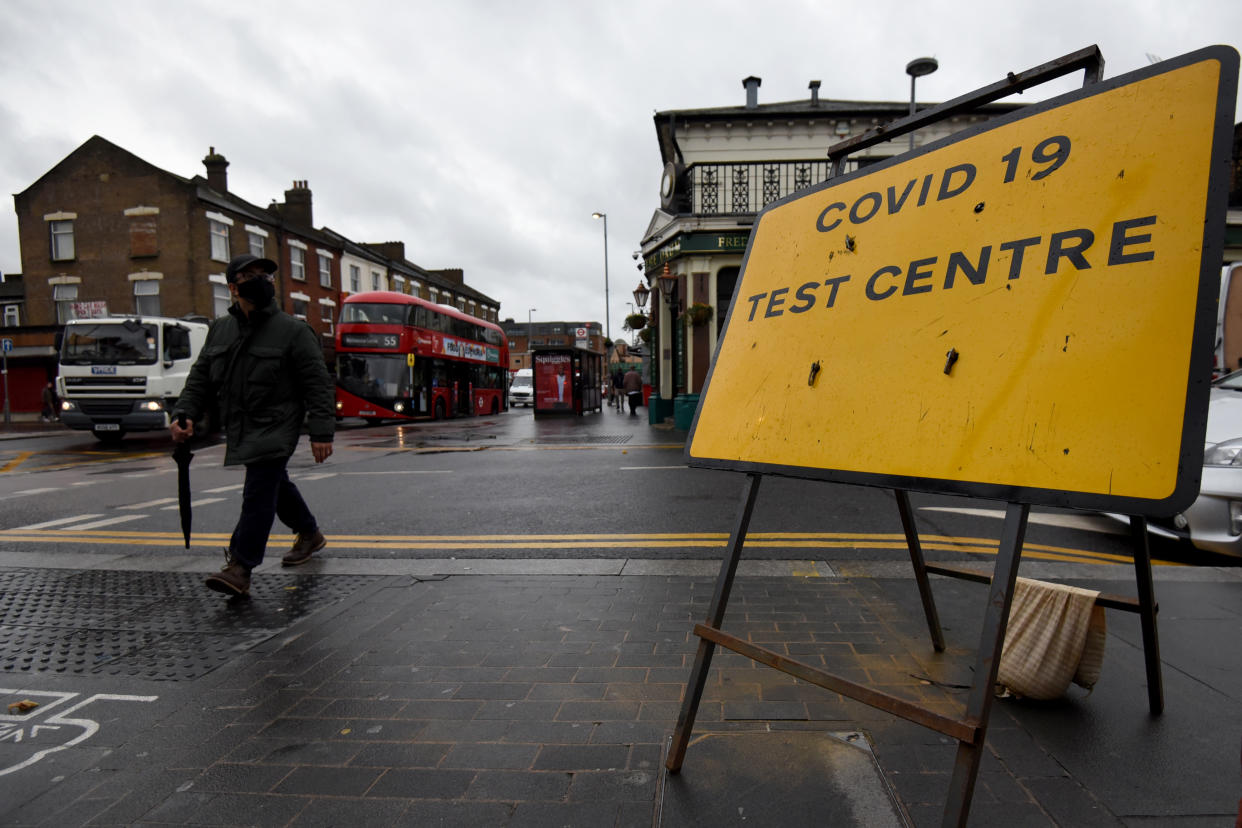 LONDON, ENGLAND - OCTOBER 29: A man walks past a coronavirus (Covid-19) testing centre in East London on October 29, 2020. The coronavirus pandemic has reached a âcritical stageâ in England with 96,000 new infections in a single day and infections doubling every nine days, according to the Imperial College London (ICL) on Thursday. Health Secretary Matt Hancock announced that 16 more areas in England will move into Tier 2 restrictions, the second highest level, beginning Saturday. (Photo by Kate Green/Anadolu Agency via Getty Images)