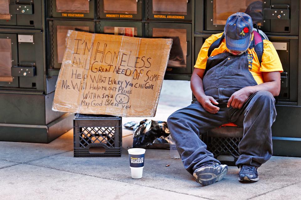 A homeless man sleeps on Illinois Street in downtown Indianapolis in 2018.