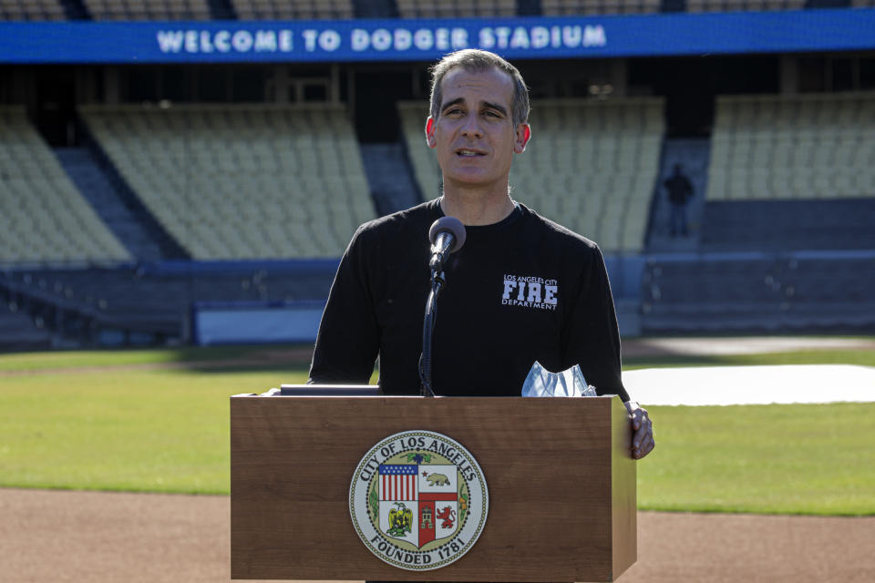 FILE - In this Jan. 15, 2021, file photo, Los Angeles Mayor Eric Garcetti addresses a press conference held at the launch of a mass COVID-19 vaccination site at Dodger Stadium in Los Angeles. Garcetti made clear in December that he would wait his turn to receive a COVID-19 vaccination, echoing county policy that nursing home residents, people 65 and older and medical workers will be first in line. But the 49-year-old Democrat was quietly vaccinated last week at the recommendation of medical personnel, after spending several days assisting healthcare workers at a large coronavirus vaccination center at Dodger Stadium. (Irfan Khan/Los Angeles Times via AP, Pool)