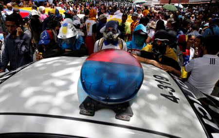 Demonstrators surround a patrol vehicle, during a rally against Venezuela's President Nicolas Maduro's government in Caracas, Venezuela June 27, 2017. REUTERS/Ivan Alvarado