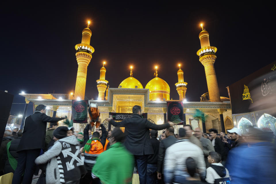 Shiite worshippers gather at the golden-domed shrine of Imam Moussa al-Kadhim, who died at the end of the eighth century, during the annual commemoration of the saint's death, in Baghdad, Iraq, Wednesday, Feb. 15, 2023. (AP Photo/Hadi Mizban)