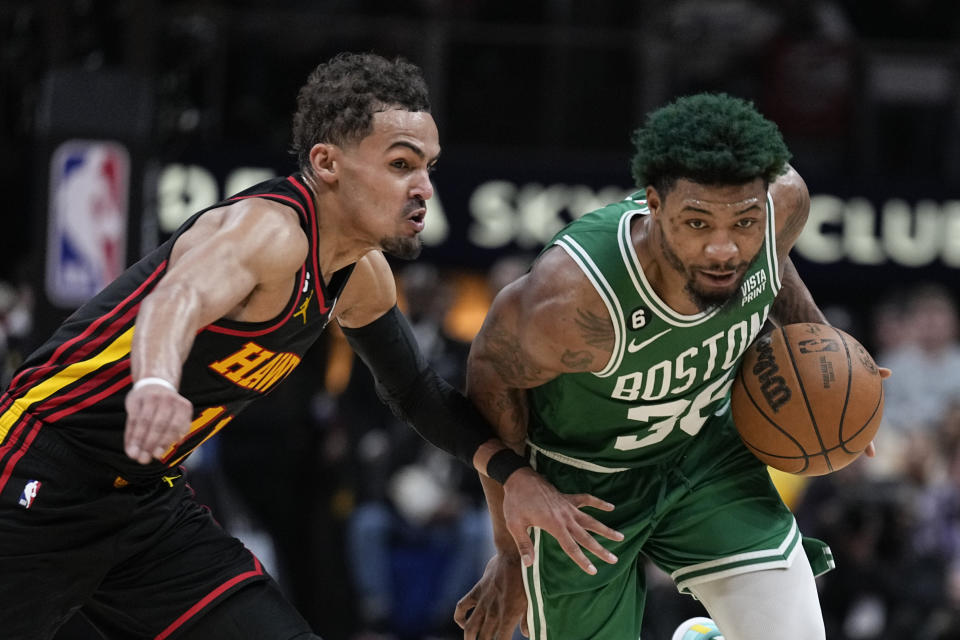 Boston Celtics guard Marcus Smart (36) dribbles against Atlanta Hawks guard Trae Young (11) during the first half of Game 4 of a first-round NBA basketball playoff series, Sunday, April 23, 2023, in Atlanta. (AP Photo/Brynn Anderson)