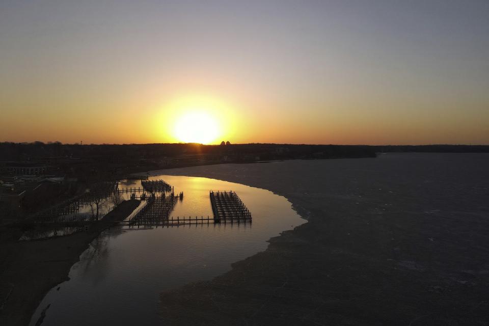 Boat docks are visible where ice has thawed at Wayzata Bay in Lake Minnetonka, Thursday, April 13, 2023, in Wayzata, Minn. (AP Photo/Abbie Parr)