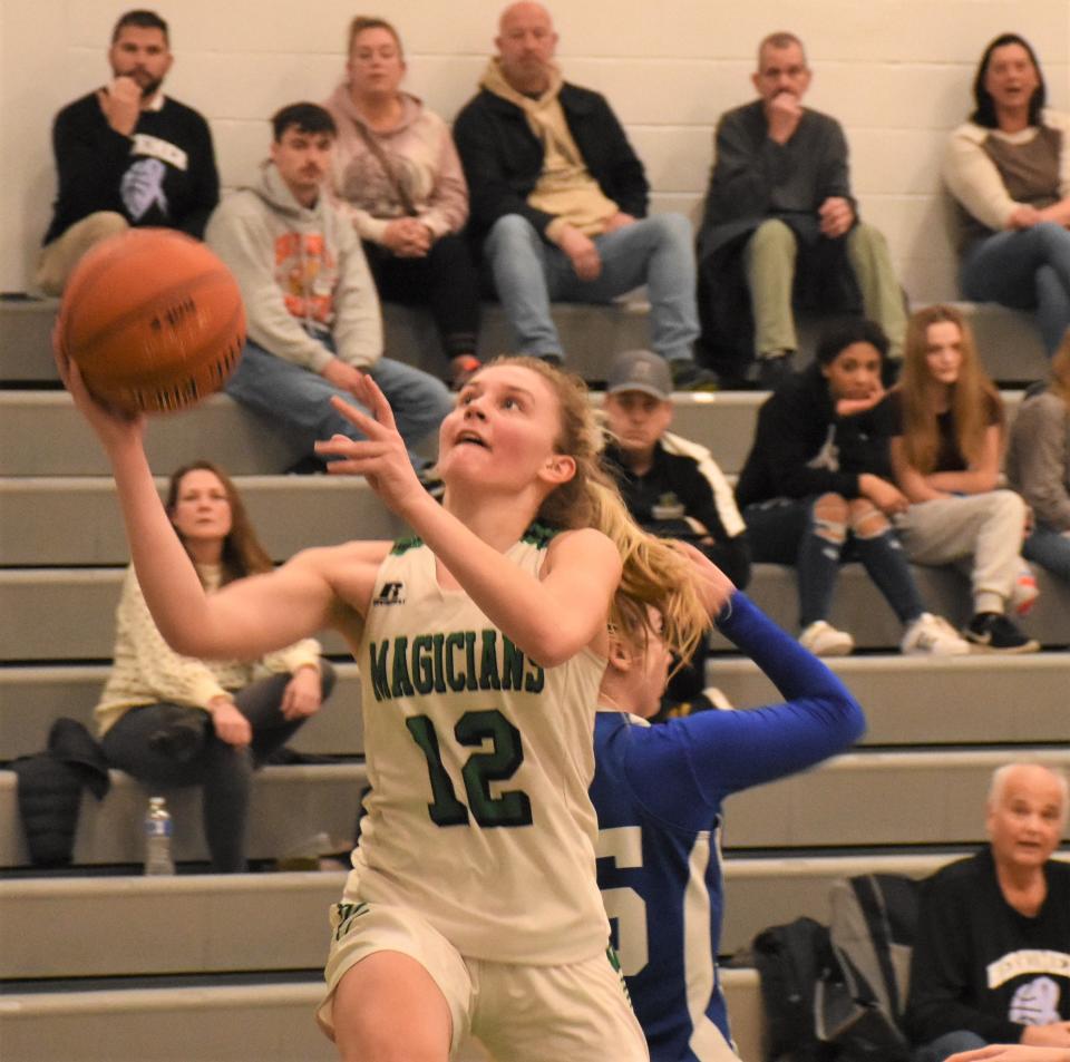 Herkimer Magician Madison Marusic (12) lays the ball up for a basket during the second half of Thursday's game against the Dolgeville Blue Devils.