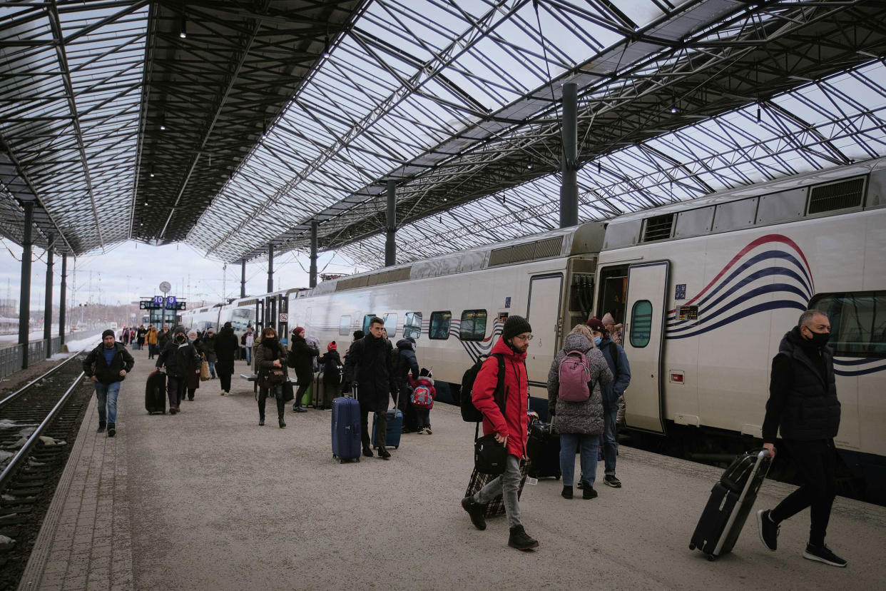 People get off the Allegro train from from St. Petersburg at the central railway station in Helsinki, Finland on March 3, 2022.