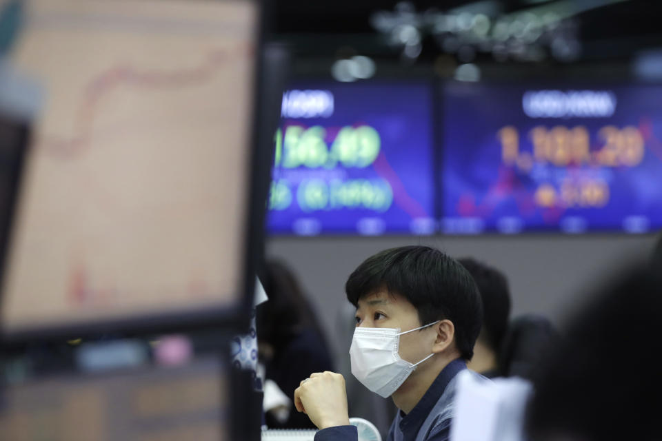 A currency trader watches computer monitors at the foreign exchange dealing room in Seoul, South Korea, Friday, Jan. 22, 2021. Asian stock markets retreated Friday after a resurgence of coronavirus infections in China and a rise in cases in Southeast Asia.(AP Photo/Lee Jin-man)